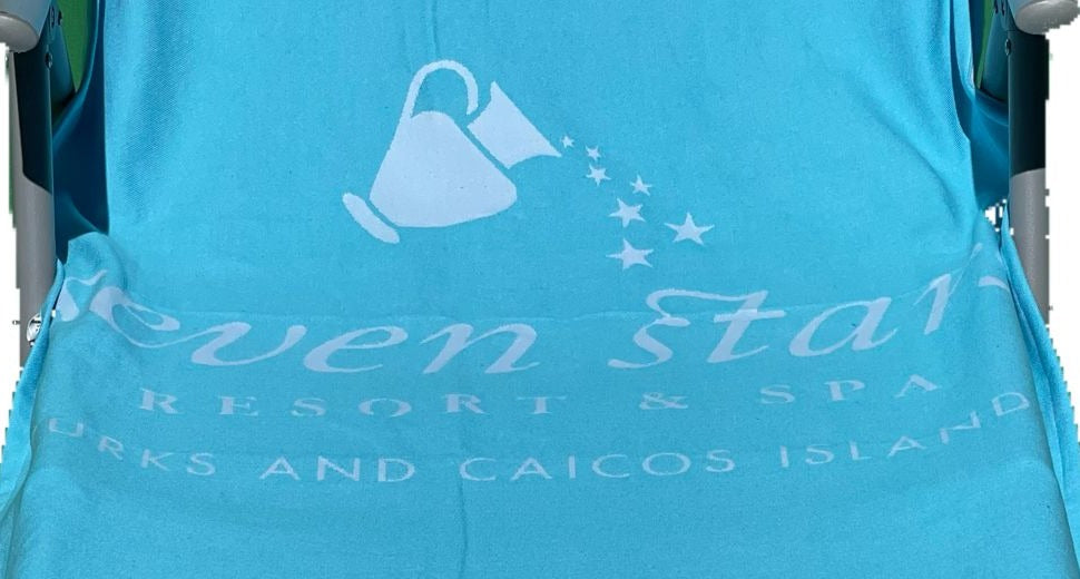 Jacquard-woven Turkish towel with watering can and star trail logo for a resort and spa, detail crop