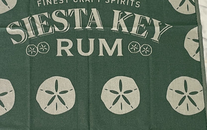 Jacquard-woven Turkish towel with Siesta Key Rum wordmark and sand dollar motif, detail crop